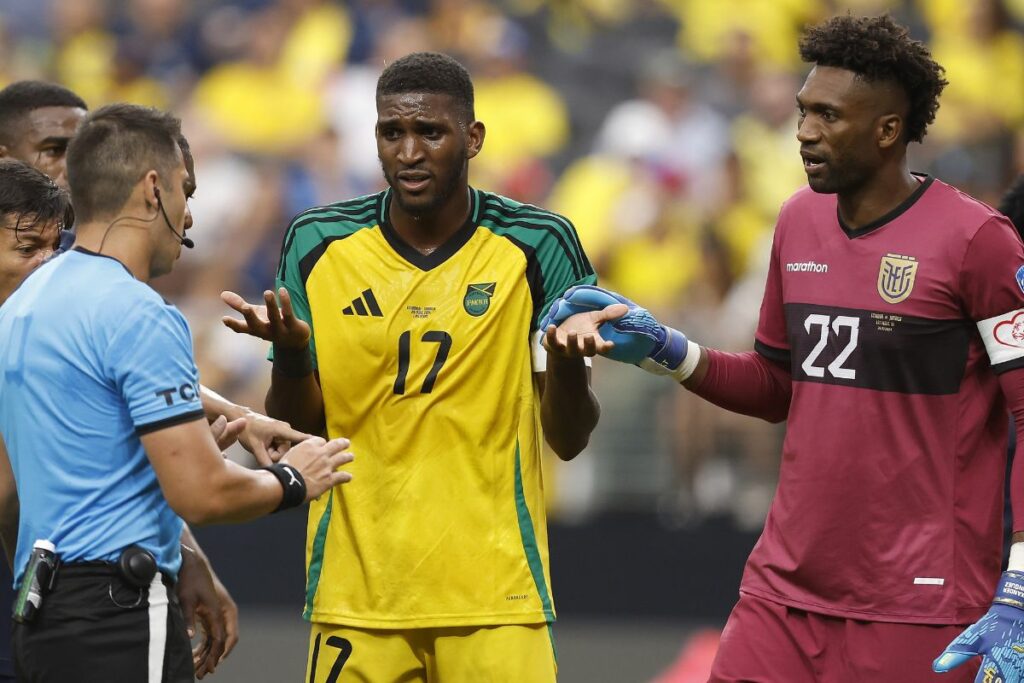 El árbtiro Cristian Garay charlando con el capitán de Jamaica Damion Lowe y el capitán de Ecuador Alexander Domínguez en un partido por Copa América 2024.